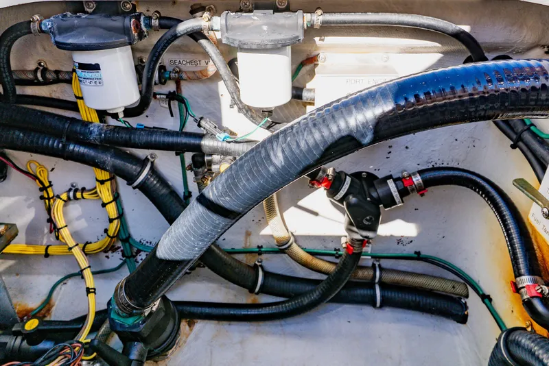 Slide: The Image of Engine compartment of 2012 SeaVee 390B boat with hoses and filters visible. - 45