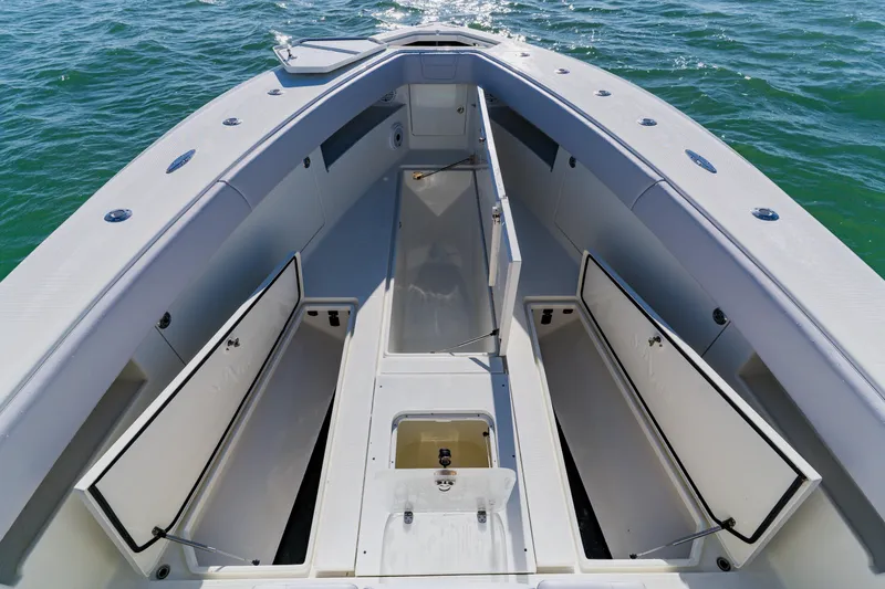 Slide: The Image of 2012 SeaVee 390B boat interior with open storage compartments on calm water. - 9