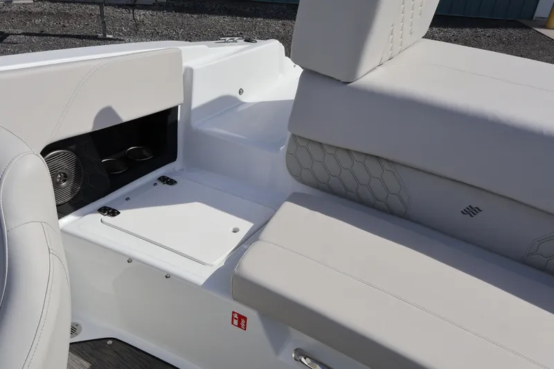 Slide: The Image of 2026 Four Winns H1 Freedom boat interior with sleek seating and storage compartments. - 12