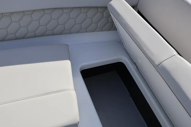 Slide: The Image of 2026 Four Winns H1 Freedom boat interior with cushioned seating and storage compartment. - 14