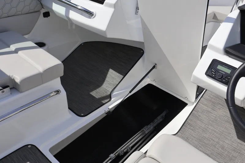 Slide: The Image of Interior of 2026 Four Winns H1 Freedom boat, featuring seating and control panel. - 18
