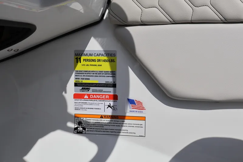 Slide: The Image of Capacity and safety labels on 2026 Four Winns H1 Freedom boat, made in USA. - 20