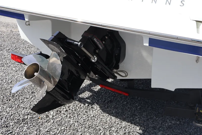 Slide: The Image of 2026 Four Winns H1 Freedom boat propeller and stern detail on gravel surface. - 5