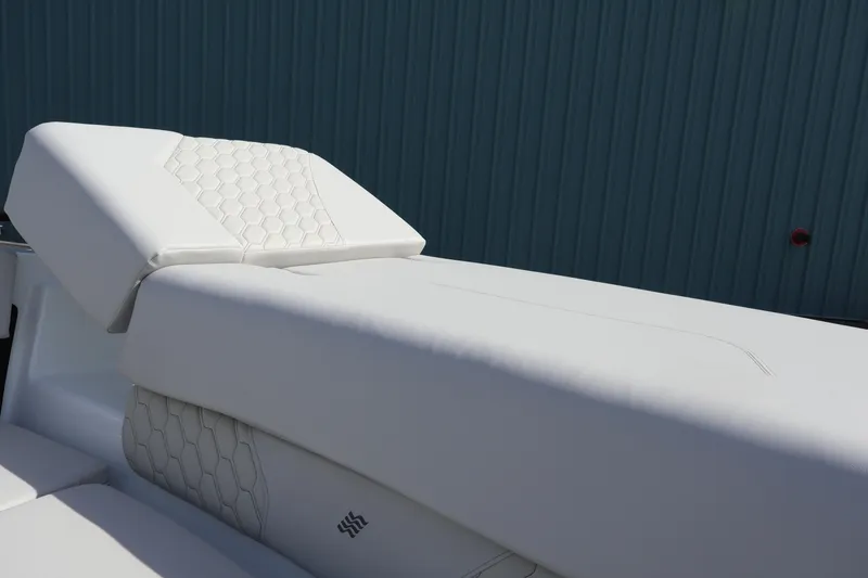 Slide: The Image of 2026 Four Winns H1 Freedom boat with luxurious white seating and hexagonal stitching design. - 9