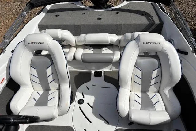 Slide: The Image of 2022 Nitro Z19 Sport boat interior with white cushioned seats and sleek design. - 10