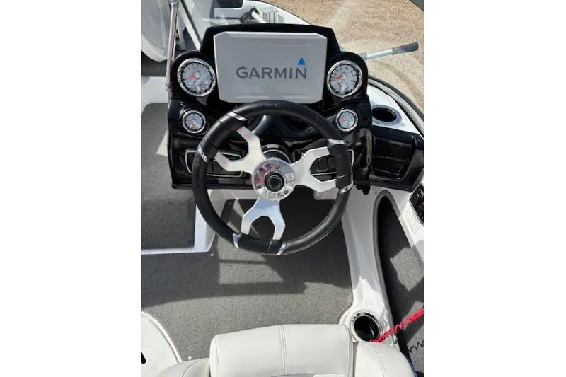 Slide: The Image of 2022 Nitro Z19 Sport boat dashboard with Garmin display and steering wheel. - 11