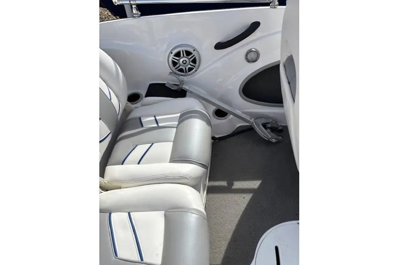 Slide: The Image of 2022 Nitro Z19 Sport boat interior with white and gray seating, speaker, and anchor. - 17