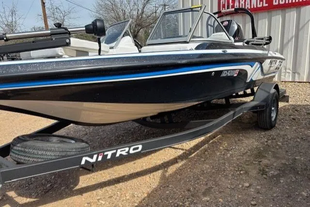 Slide: The Image of 2022 Nitro Z19 Sport boat on trailer, black and white design, parked outdoors. - 19