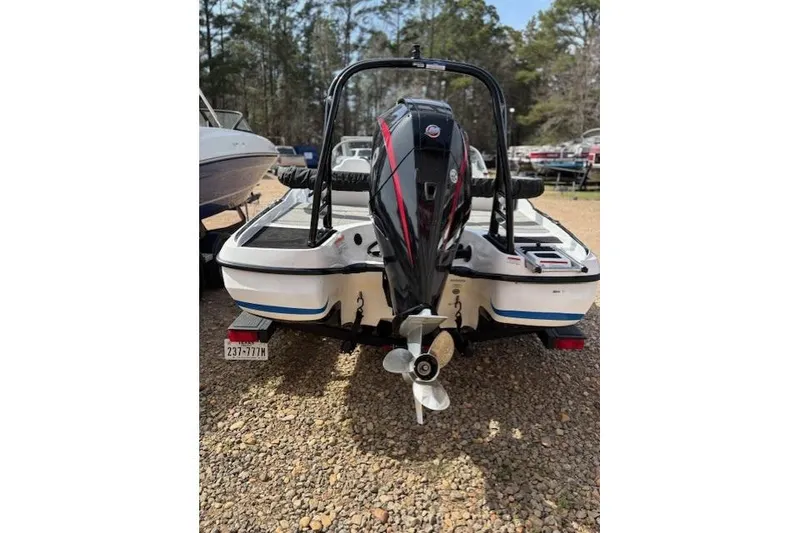 Slide: The Image of 2022 Nitro Z19 Sport boat with powerful outboard motor, parked on gravel. - 20