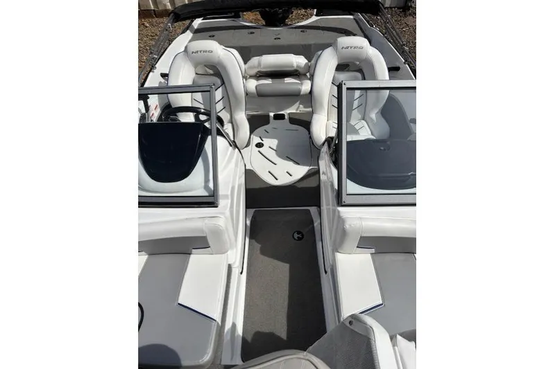 Slide: The Image of 2022 Nitro Z19 Sport boat interior with white seating and dual consoles. - 9