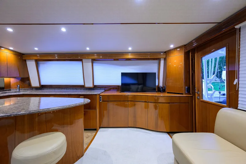 Slide: The Image of Luxurious interior of 2015 Viking 62 Convertible yacht with modern wood finishes and seating. - 14