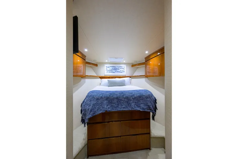 Slide: The Image of Luxurious cabin interior of 2015 Viking 62 Convertible yacht with cozy bed and wooden cabinetry. - 19