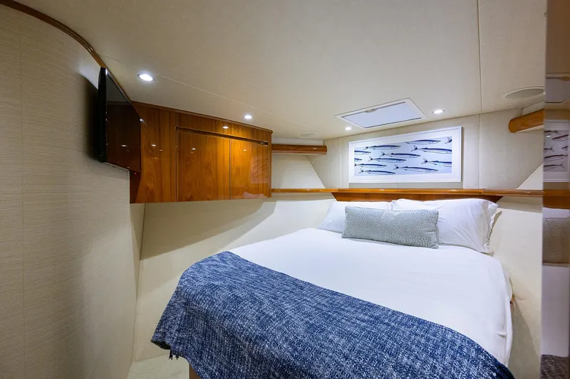 Slide: The Image of Luxurious cabin interior of 2015 Viking 62 Convertible yacht with cozy bed and elegant decor. - 21