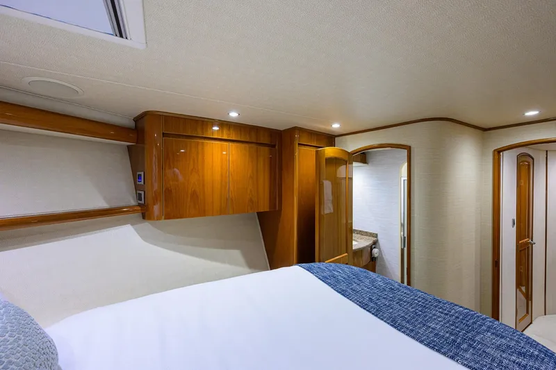 Slide: The Image of Luxurious interior of 2015 Viking 62 Convertible yacht with wood cabinetry and cozy bedding. - 23