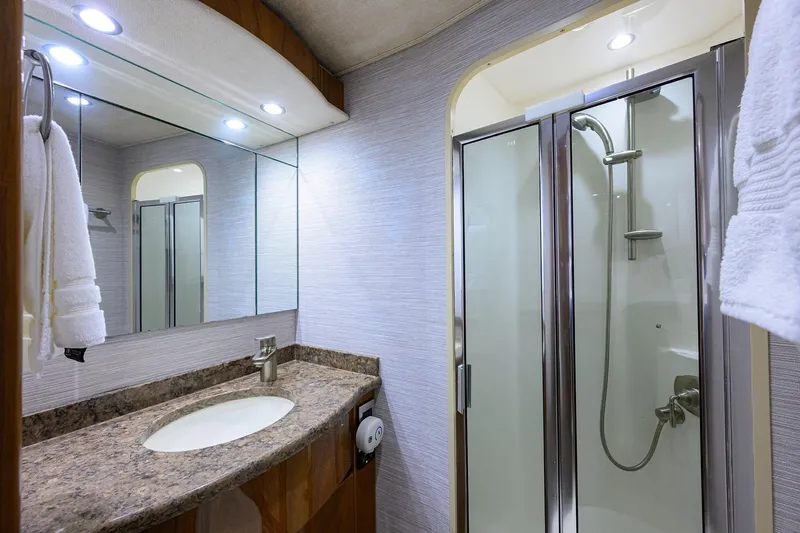 Slide: The Image of Luxurious bathroom in 2015 Viking 62 Convertible yacht with modern shower and vanity. - 26