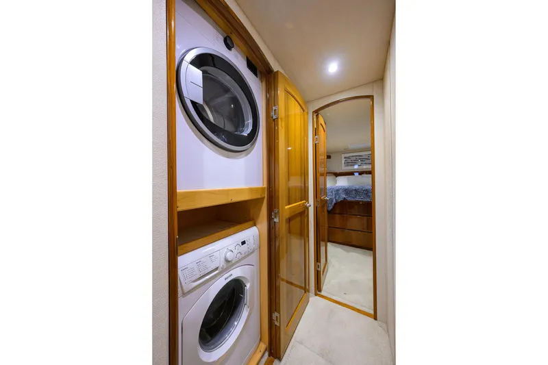 Slide: The Image of Laundry area in 2015 Viking 62 Convertible yacht with washer and dryer. - 39