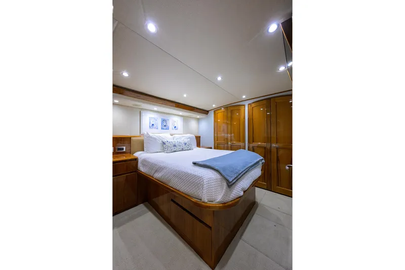Slide: The Image of Luxurious bedroom interior of 2015 Viking 62 Convertible yacht with elegant wood finishes. - 40