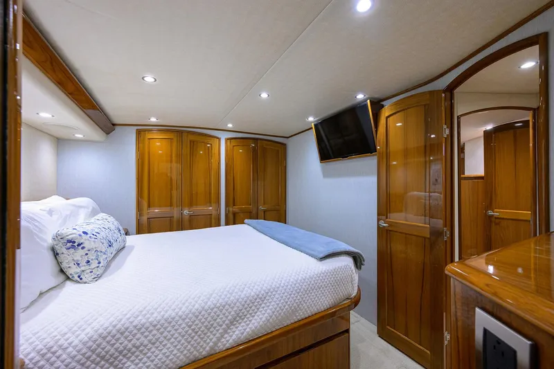 Slide: The Image of Luxurious bedroom interior of 2015 Viking 62 Convertible yacht with wood finishes and modern amenities. - 42