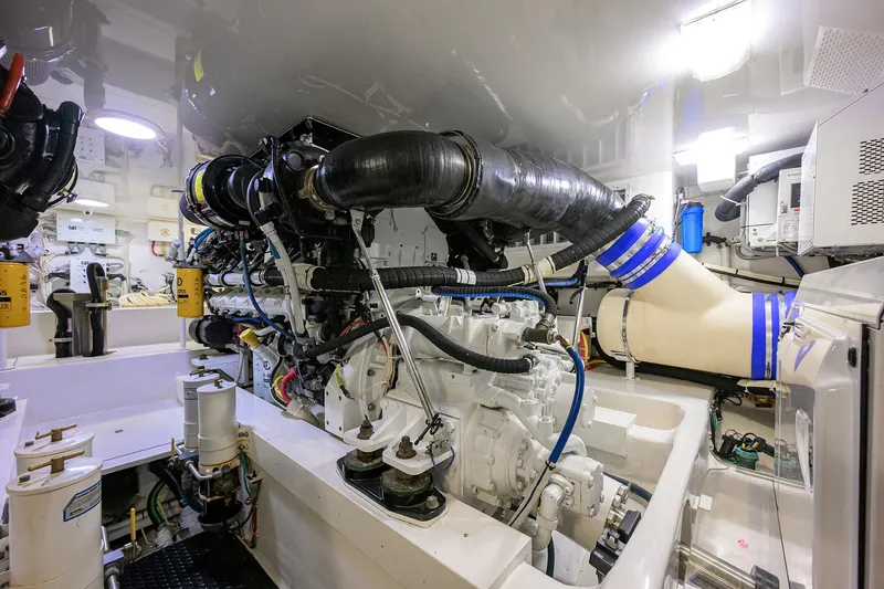 Slide: The Image of Engine room of 2015 Viking 62 Convertible yacht, showcasing complex machinery and components. - 56