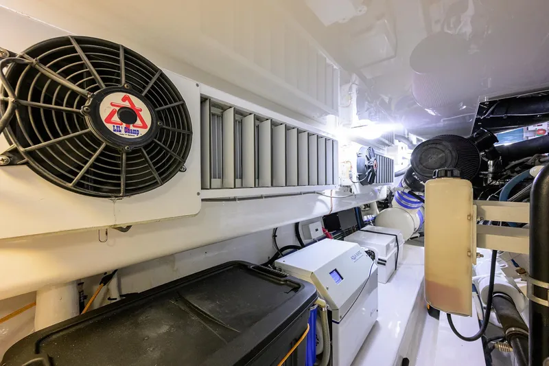 Slide: The Image of Engine room of 2015 Viking 62 Convertible yacht, featuring ventilation and machinery systems. - 64