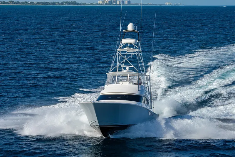 Slide: The Image of 2015 Viking 62 Convertible yacht cruising on open ocean waters. - 69
