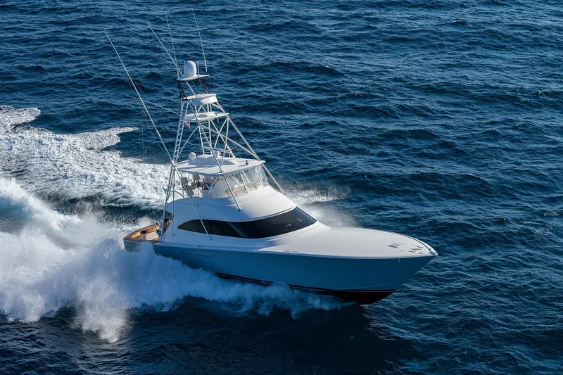 Slide: The Image of 2015 Viking 62 Convertible yacht cruising on open ocean waters. - 70
