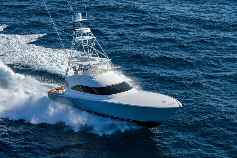 Slide: The Image of 2015 Viking 62 Convertible yacht cruising on open ocean waters. - 71