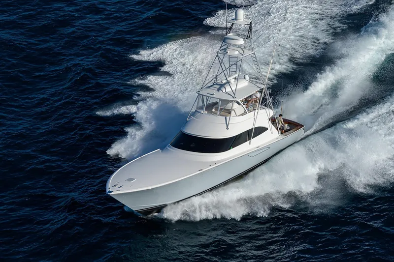 Slide: The Image of 2015 Viking 62 Convertible yacht cruising swiftly on open ocean waters. - 72