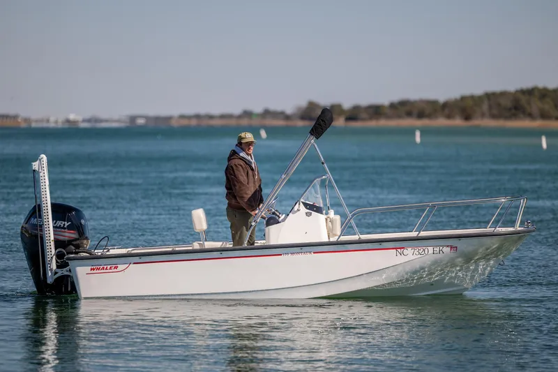 Slide: The Image of 2018 Boston Whaler 170 Montauk boat on calm water with a person onboard. - 1