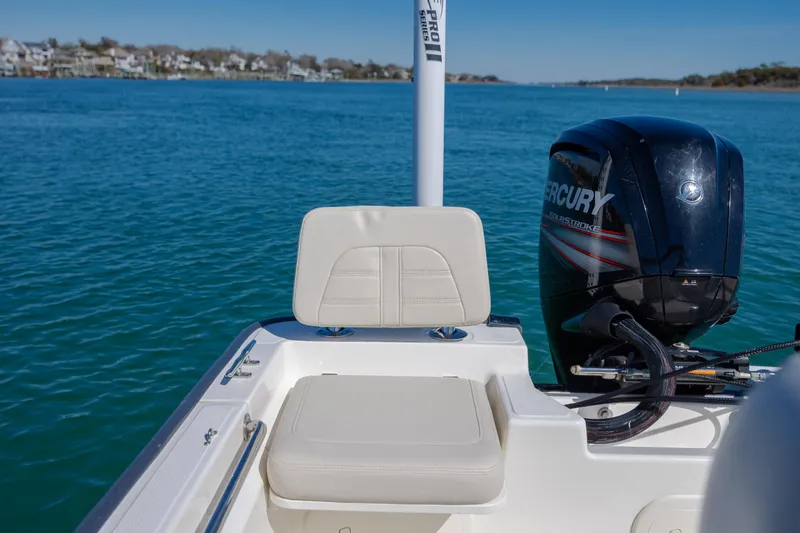 Slide: The Image of 2018 Boston Whaler 170 Montauk boat with Mercury engine on calm blue water. - 10
