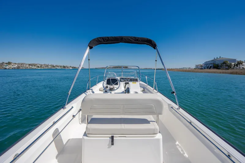 Slide: The Image of 2018 Boston Whaler 170 Montauk boat on calm blue water under clear sky. - 12
