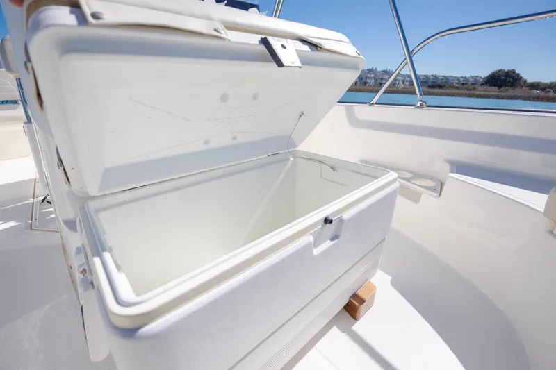 Slide: The Image of Open cooler on 2018 Boston Whaler 170 Montauk boat, with scenic water view. - 16