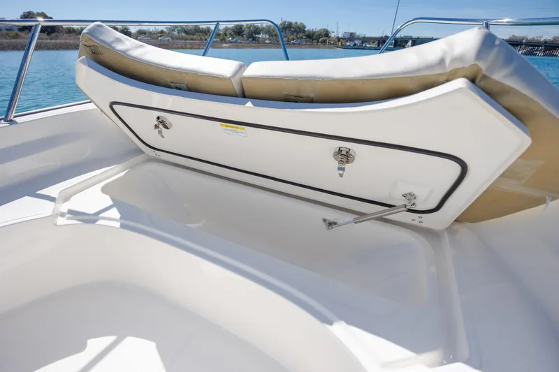 Slide: The Image of 2018 Boston Whaler 170 Montauk boat storage compartment open on deck. - 17