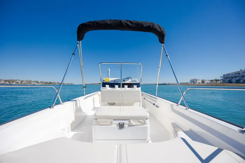 Slide: The Image of 2018 Boston Whaler 170 Montauk boat on calm blue water under clear sky. - 18
