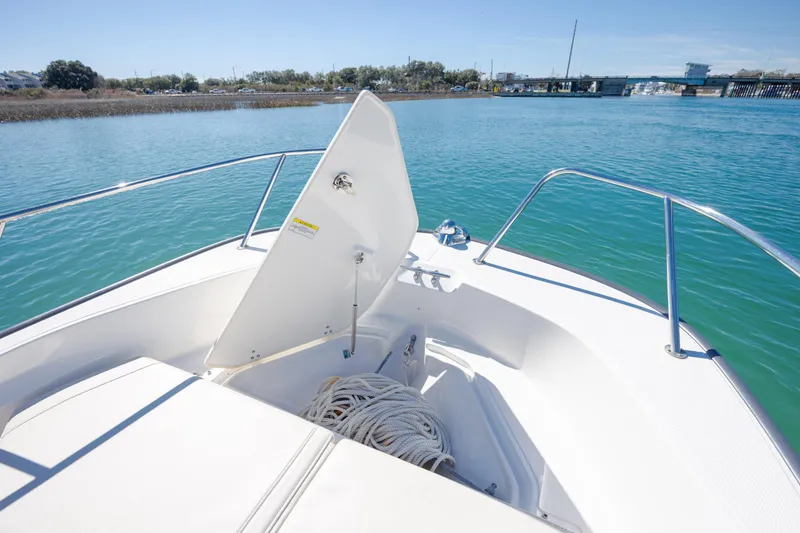 Slide: The Image of 2018 Boston Whaler 170 Montauk boat with open storage compartment on calm water. - 20