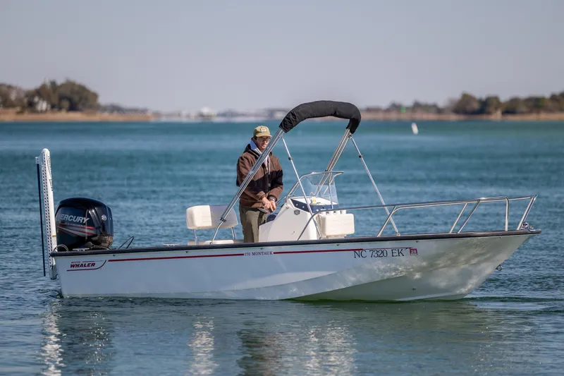 Slide: The Image of 2018 Boston Whaler 170 Montauk boat on calm water with a person onboard. - 3