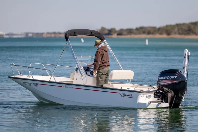 Slide: The Image of 2018 Boston Whaler 170 Montauk boat on calm water with Mercury engine. - 6