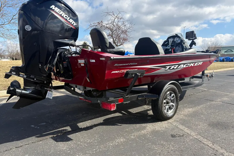 Slide: The Image of 2021 Tracker Pro Team 175 TXW Tournament Edition boat with Mercury engine, parked outdoors. - 4