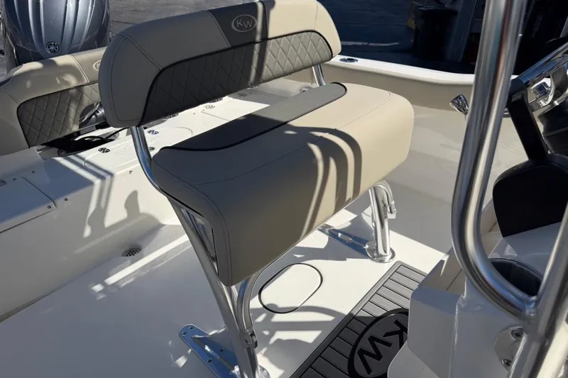 Slide: The Image of 2026 Key West 203 FS boat interior with cushioned seating and stainless steel fixtures. - 17