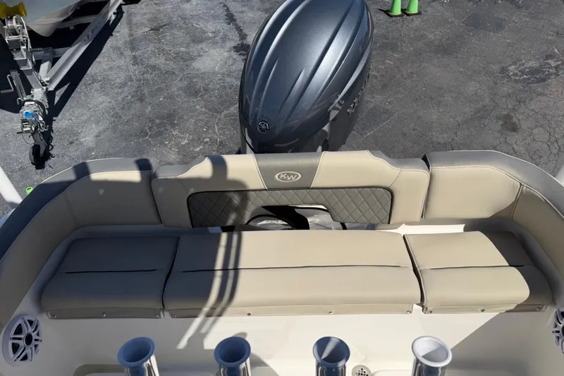 Slide: The Image of 2026 Key West 203 FS boat interior with cushioned seating and outboard motor. - 18