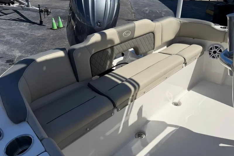 Slide: The Image of 2026 Key West 203 FS boat interior with beige seating and cup holders. - 19