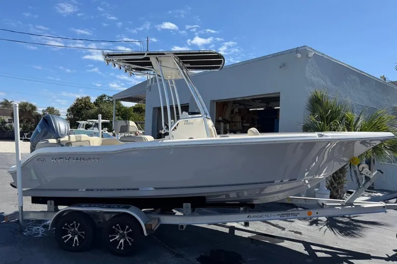 Slide: The Image of 2026 Key West 203 FS boat on trailer, parked outdoors under clear sky. - 2