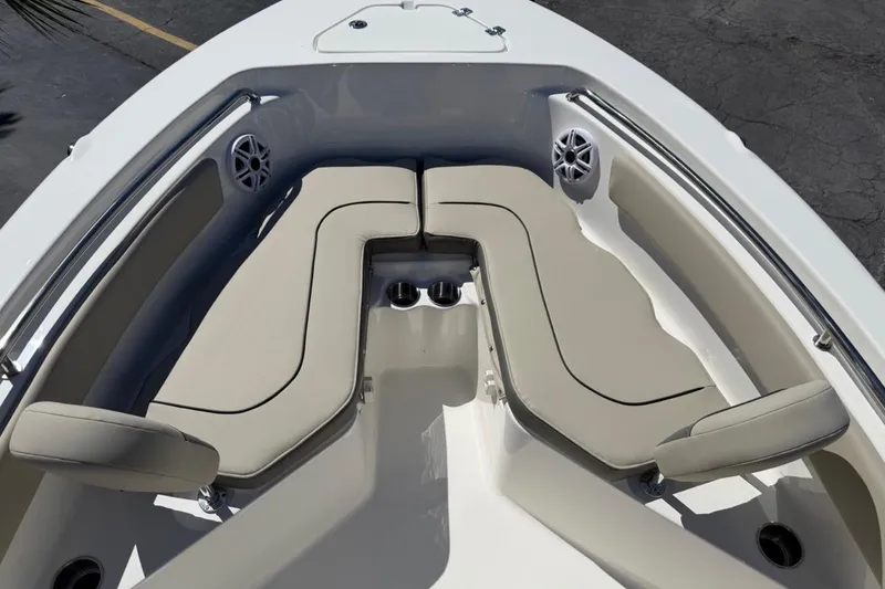 Slide: The Image of 2026 Key West 203 FS boat interior with beige seating and cup holders. - 23