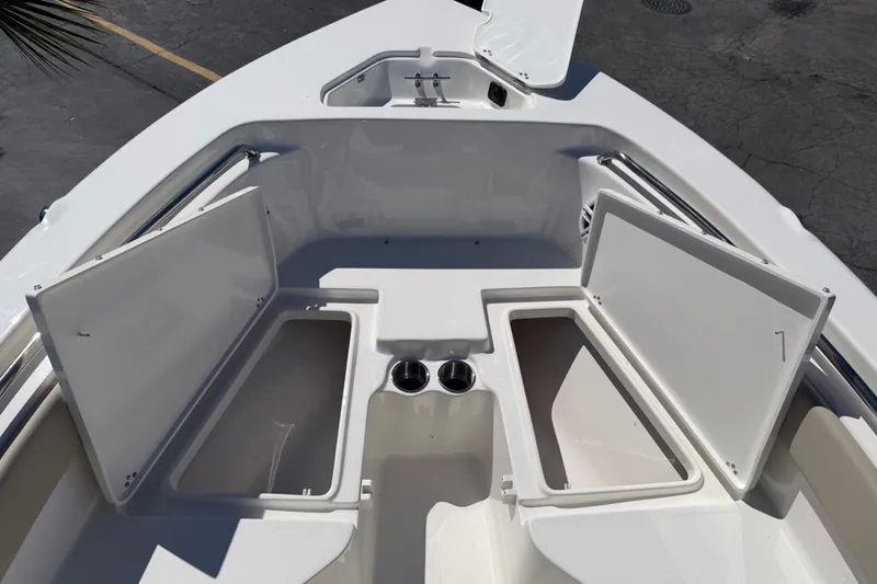 Slide: The Image of 2026 Key West 203 FS boat with open storage compartments and cup holders. - 25