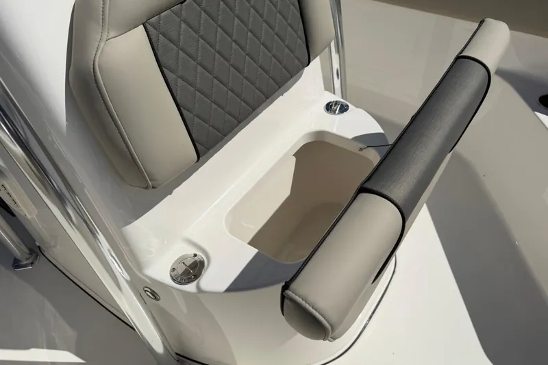 Slide: The Image of 2026 Key West 203 FS boat seat with storage compartment, featuring gray and beige upholstery. - 27