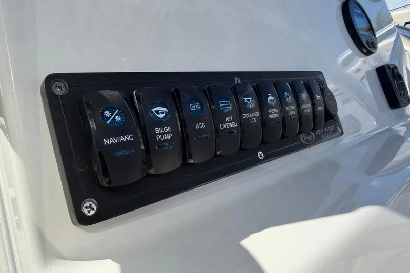 Slide: The Image of Control panel of 2026 Key West 203 FS boat with labeled switches. - 29