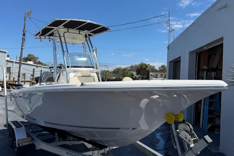 Slide: The Image of 2026 Key West 203 FS boat on trailer, parked outdoors under clear sky. - 3