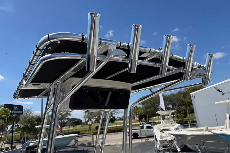 Slide: The Image of T-top of 2026 Key West 203 FS boat with rod holders under clear blue sky. - 33