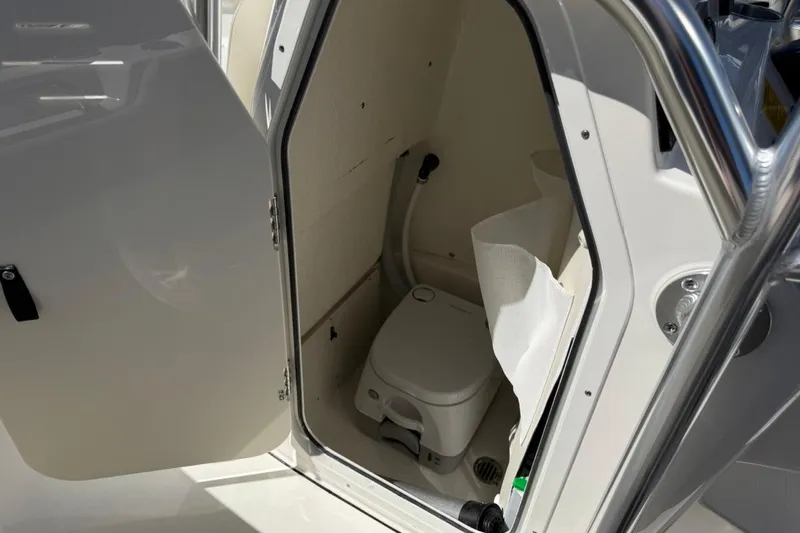 Slide: The Image of 2026 Key West 203 FS boat interior with compact marine toilet. - 37