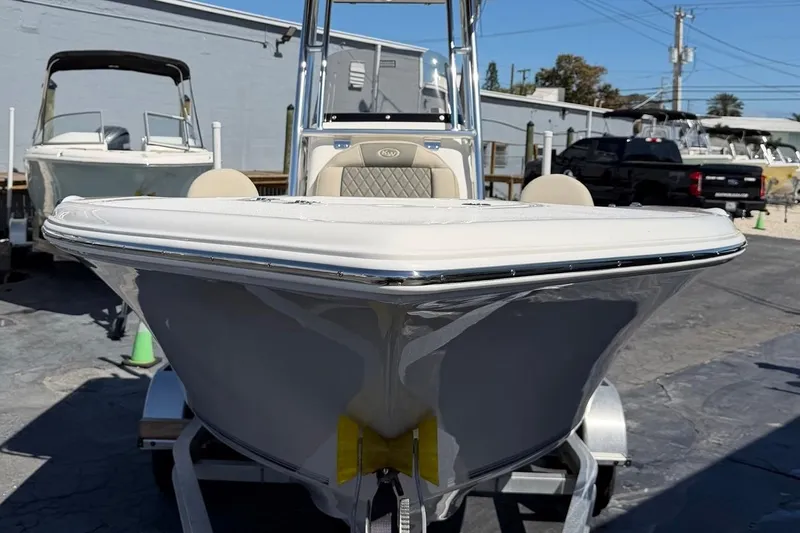 Slide: The Image of 2026 Key West 203 FS boat on trailer, displayed outdoors in a marina setting. - 4